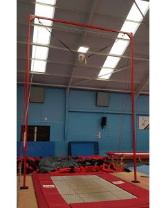 Floor mounted trampoline spotting rig